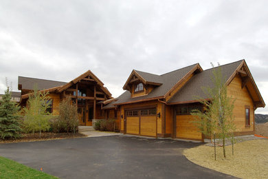 Large rustic brown two-story wood gable roof idea in Denver