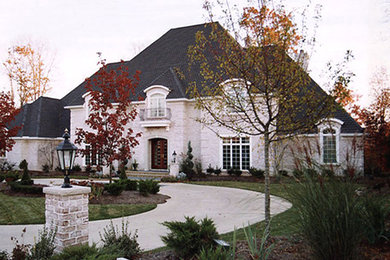 Example of a large classic white two-story house exterior design in Cleveland with a clipped gable roof and a tile roof