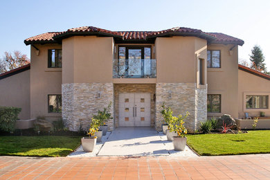 Example of a large minimalist beige one-story stucco house exterior design in Boise with a shingle roof