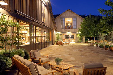 Photo of a rural two floor detached house in Los Angeles with wood cladding and a pitched roof.