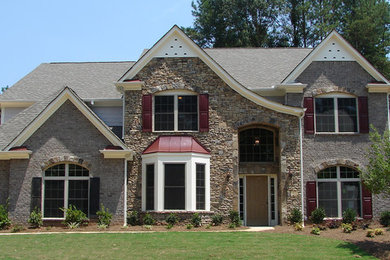 Example of a large beige two-story mixed siding exterior home design in Atlanta