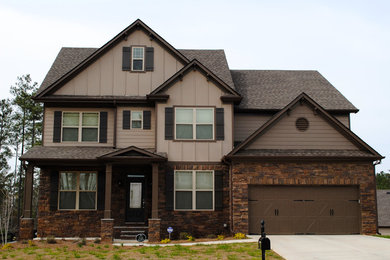 Large arts and crafts brown two-story mixed siding exterior home photo in Atlanta with a shingle roof