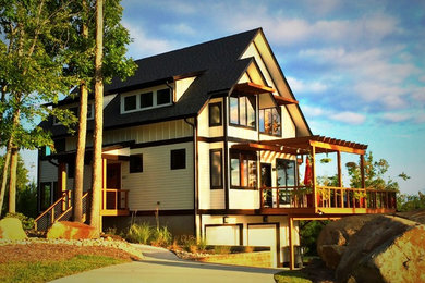 Photo of a white and large traditional house exterior in Raleigh with concrete fibreboard cladding and three floors.