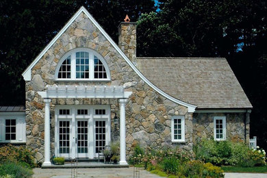 Mid-sized traditional beige two-story stone exterior home idea in Boston with a shingle roof
