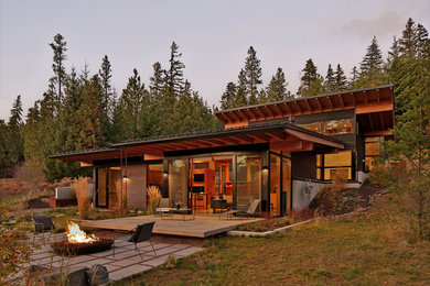Inspiration for a mid-sized modern black two-story metal house exterior remodel in Seattle with a shed roof and a metal roof