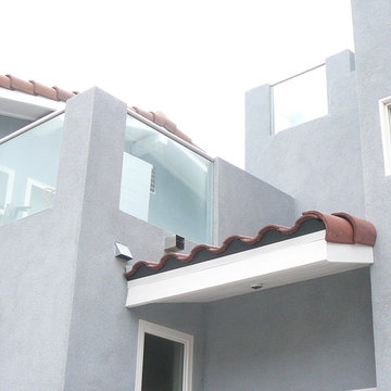 New addition connecting to original - weaving glass and stucco with tile roof
