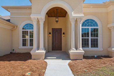 Mid-sized mediterranean beige one-story stucco house exterior idea in Atlanta with a hip roof and a shingle roof