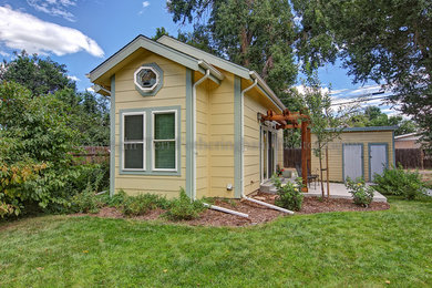 Small modern yellow exterior home idea in Denver
