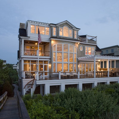 Large coastal brown three-story wood exterior home idea in Philadelphia