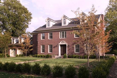 Inspiration for an expansive and red traditional brick house exterior in New York with three floors.