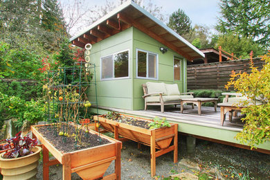 Small craftsman green one-story house exterior idea in Seattle with a shed roof
