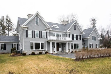 Large transitional gray two-story mixed siding gable roof photo in New York