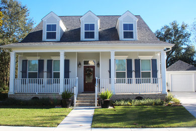 Inspiration for a mid-sized timeless white two-story wood exterior home remodel in New Orleans with a shingle roof