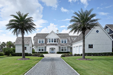 Large transitional white two-story wood house exterior idea in Jacksonville with a shingle roof