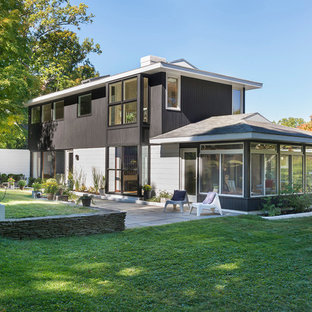 Inspiration for a 1960s brown two-story mixed siding exterior home remodel in Boston with a hip roof