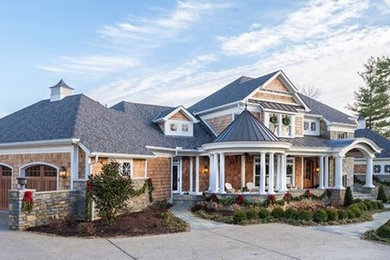 Inspiration for a large craftsman beige two-story wood exterior home remodel in Cincinnati with a shingle roof