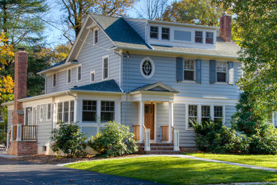 Mid-sized traditional blue three-story wood exterior home idea in New York with a shingle roof