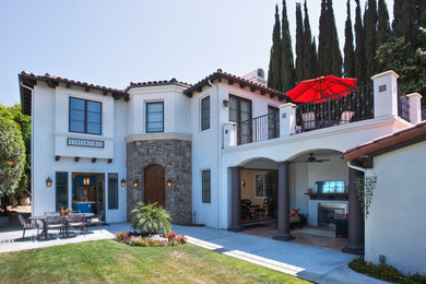 Inspiration for a large mediterranean beige two-story exterior home remodel in Los Angeles