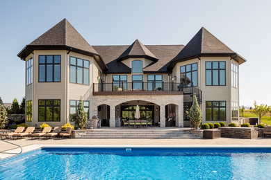 Huge elegant two-story stone gable roof photo in Other