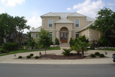 Photo of a medium sized and beige mediterranean two floor concrete house exterior in Austin.