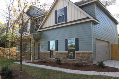 Mid-sized transitional blue two-story vinyl house exterior photo in Atlanta with a hip roof and a shingle roof
