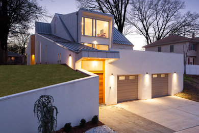 Large modern white two-story concrete fiberboard exterior home idea in New York with a shed roof