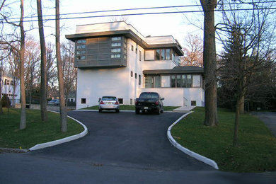 Example of a mid-sized minimalist white three-story house exterior design in New York