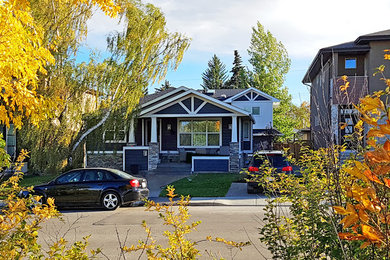 Inspiration for a craftsman blue concrete fiberboard gable roof remodel in Calgary with a shingle roof