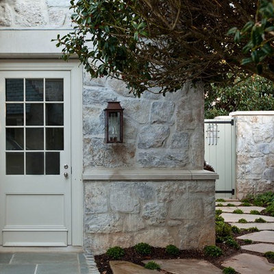 Mid-sized traditional gray two-story stone house exterior idea in Charlotte with a hip roof and a shingle roof
