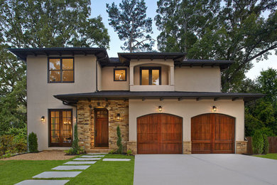Large beige two-story stucco house exterior photo in Orange County with a hip roof and a shingle roof