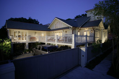 This is an example of a large and white classic two floor house exterior in New Orleans with wood cladding.