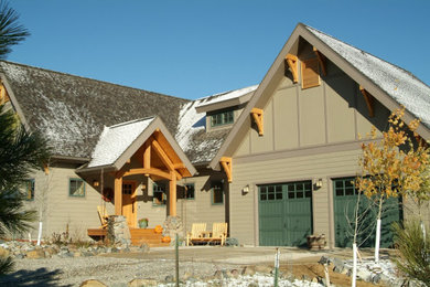 Large mountain style beige two-story mixed siding exterior home photo in Other with a shingle roof