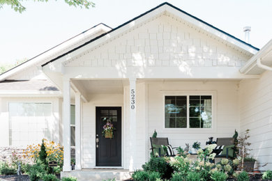 Small country white one-story wood exterior home photo in Boise with a shingle roof