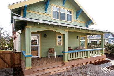 Arts and crafts green two-story wood exterior home photo in Seattle