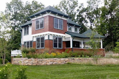 Large traditional multicolored two-story mixed siding house exterior idea in Grand Rapids with a hip roof and a shingle roof