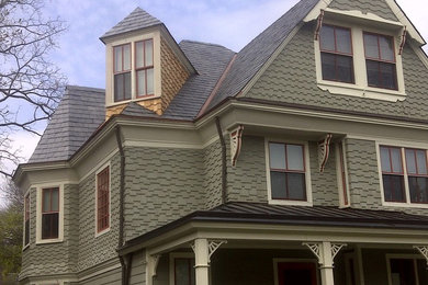 Example of a classic green three-story vinyl exterior home design in Philadelphia