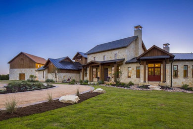 Photo of an expansive and beige rural two floor detached house in Austin with a pitched roof, mixed cladding and a tiled roof.