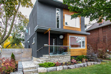 Example of a mid-sized minimalist gray two-story house exterior design in Toronto