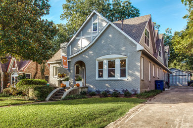 Inspiration for a mid-sized timeless gray two-story brick gable roof remodel in Dallas
