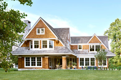 Inspiration for a timeless brown two-story wood exterior home remodel in Providence with a shingle roof