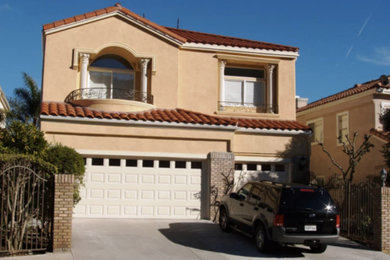 Example of a large tuscan beige two-story stucco exterior home design in Phoenix with a tile roof