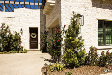 Inspiration for a mid-sized mediterranean beige one-story stone exterior home remodel in Orange County