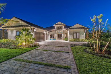 Example of a mid-sized transitional white one-story stucco gable roof design in Miami