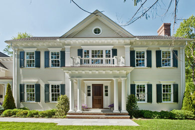 Inspiration for a large timeless yellow two-story wood exterior home remodel in Boston with a shingle roof