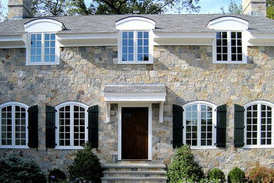 Large traditional two-story stone exterior home idea in Boston with a shingle roof
