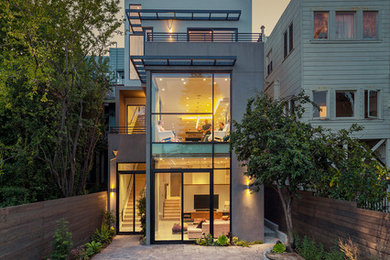 Large trendy three-story flat roof photo in San Francisco