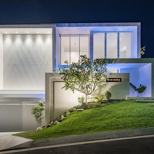 Large contemporary white house exterior in Melbourne with a flat roof.