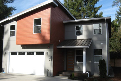 Inspiration for a large contemporary gray two-story concrete fiberboard exterior home remodel in Seattle with a shed roof