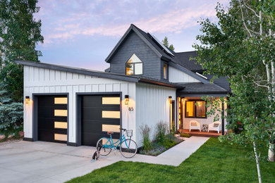 Example of a mid-sized transitional white one-story wood house exterior design in Denver with a shed roof and a metal roof