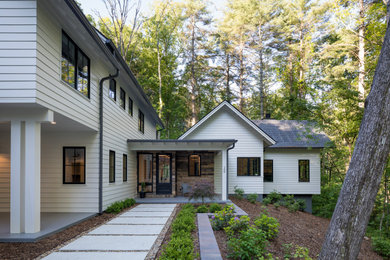Example of a large cottage white two-story concrete fiberboard exterior home design in Other with a shingle roof